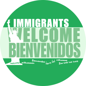 Round green & white button with silhouette of statue of liberty and the text Immigrants Welcome, welcome in several languages